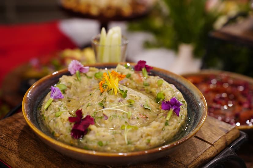 Artisanal eggplant dip garnished with edible flowers served as part of a lavish spread at Saj in the Forest, Pench.