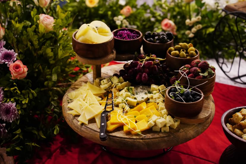Gourmet cheese and fruit platter beautifully arranged on a wooden board at Saj in the Forest resort, Pench.