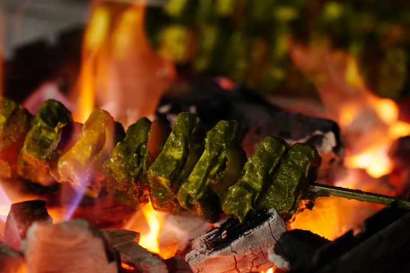 Freshly grilled seekh kebabs over open charcoal fire at Saj in the Forest resort, Pench National Park.