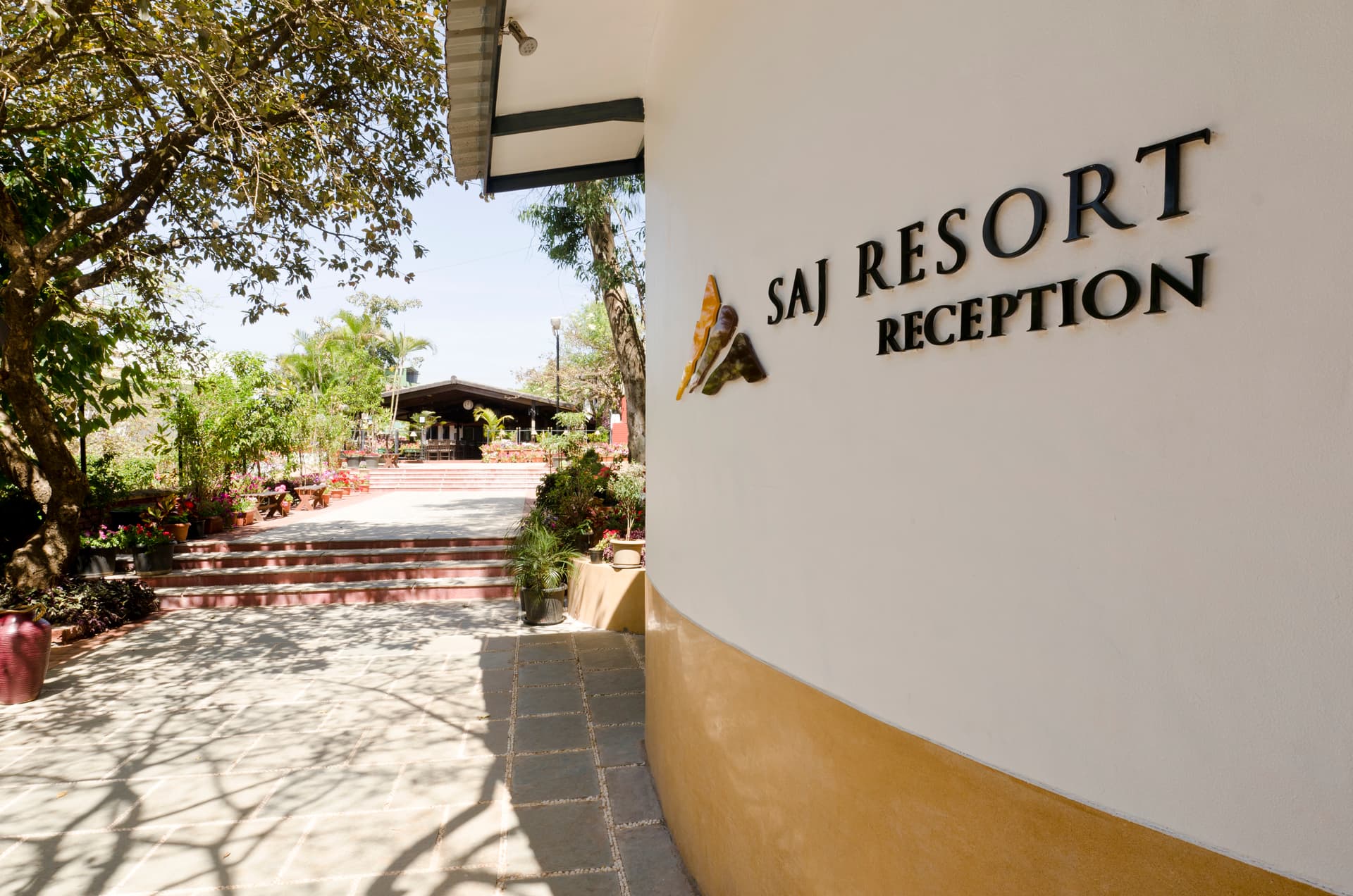 Saj Resort Mahabaleshwar entrance sign welcoming guests to a premium mountain stay.