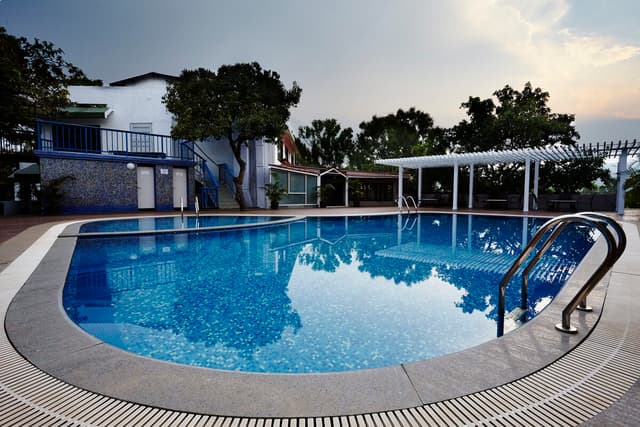 Large outdoor swimming pool at Saj On The Mountain, the ideal Mahabaleshwar resort for family with swimming pool.